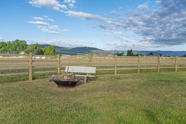 view of yard with a rural view and a mountain view