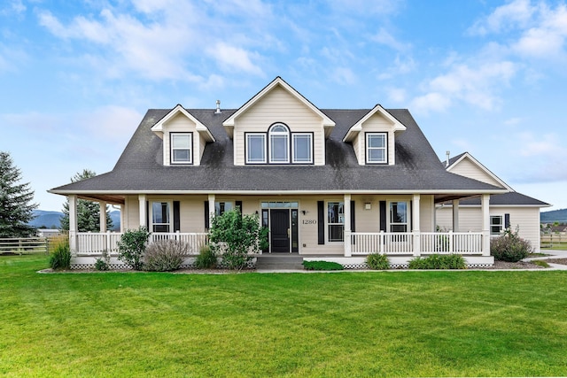 farmhouse inspired home featuring a front yard and covered porch