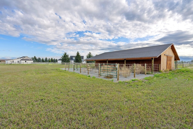 view of yard with an outdoor structure and a rural view