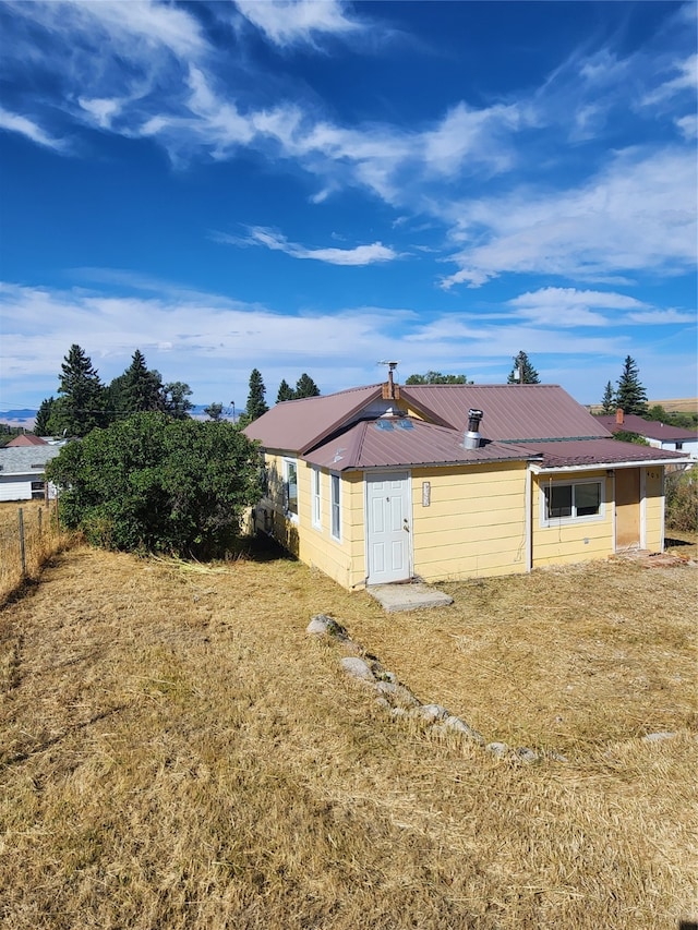 back of house with a lawn