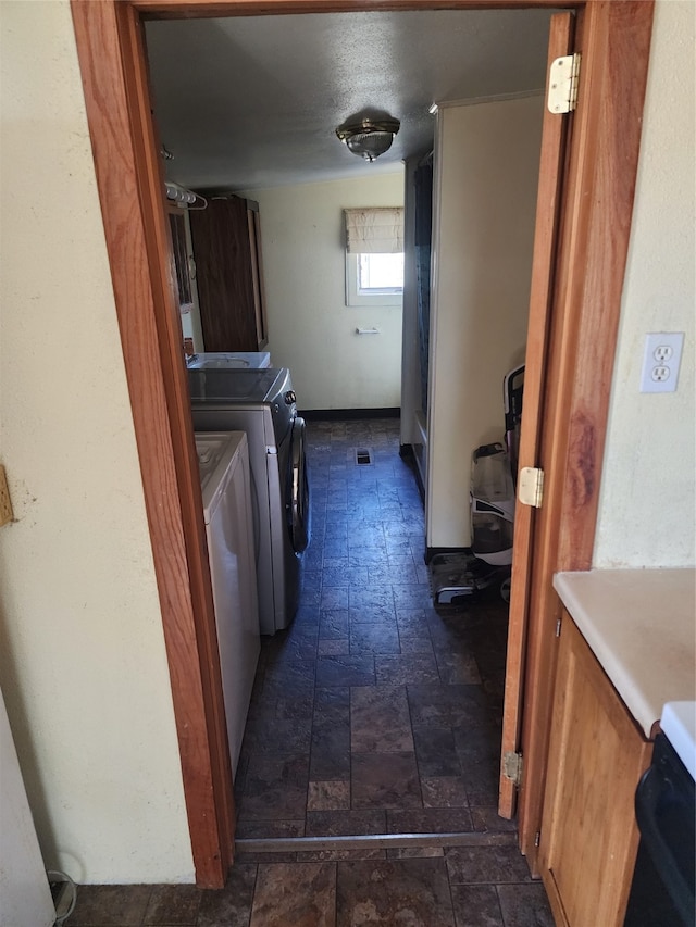 hallway with washer and clothes dryer