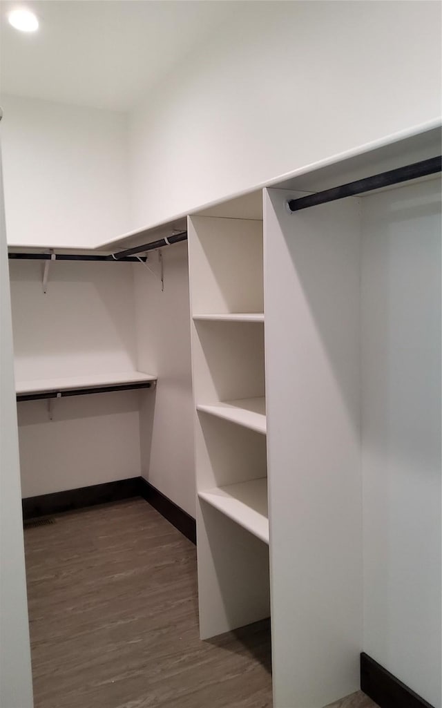 walk in closet featuring dark hardwood / wood-style flooring