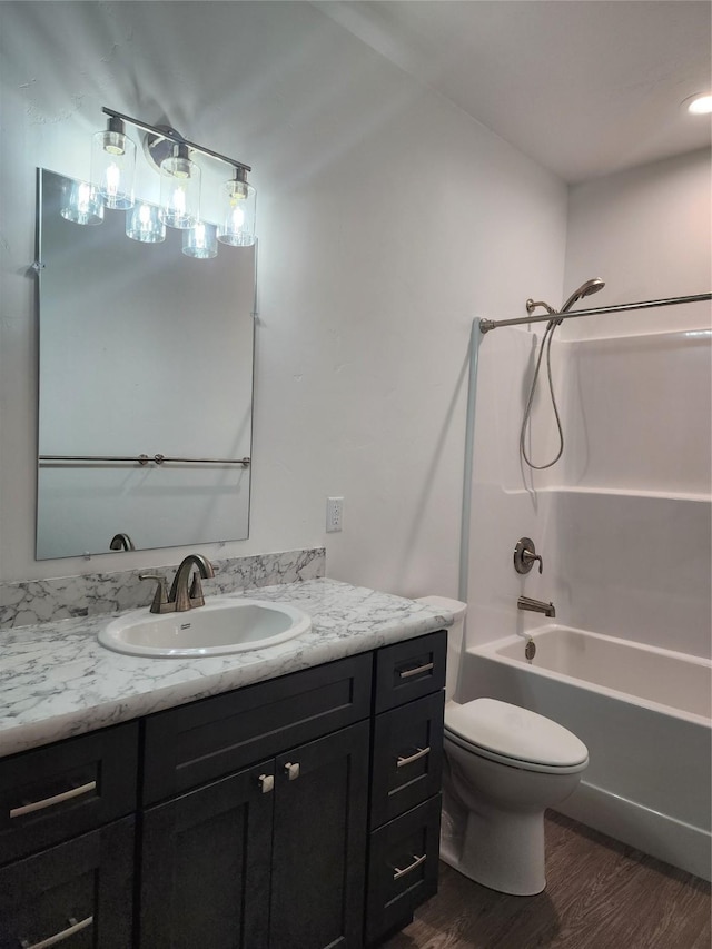 full bathroom featuring vanity, wood-type flooring, tub / shower combination, and toilet