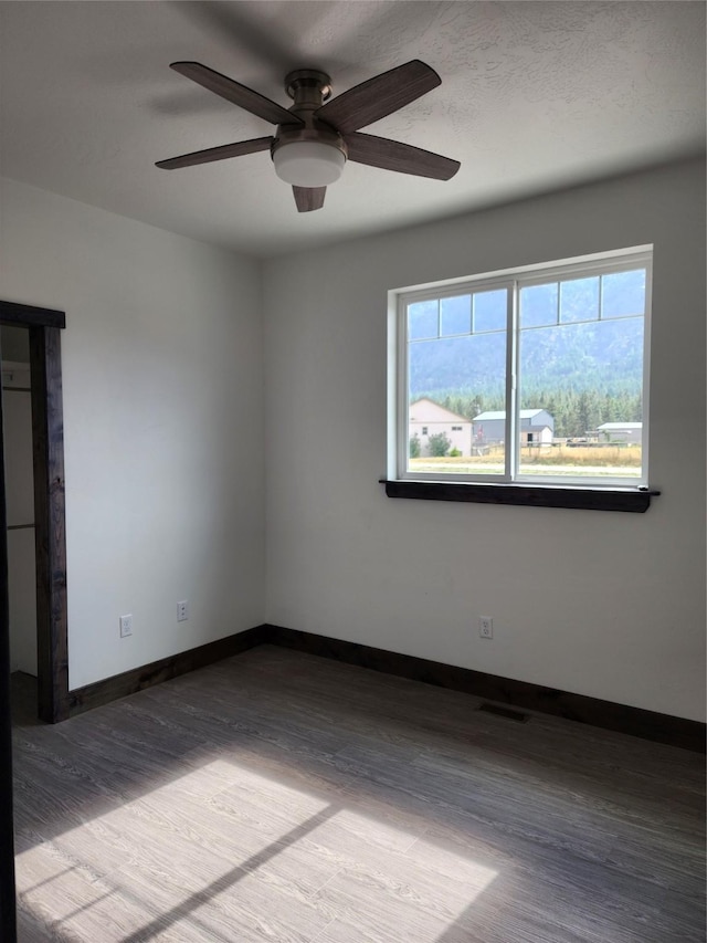 unfurnished room featuring hardwood / wood-style flooring