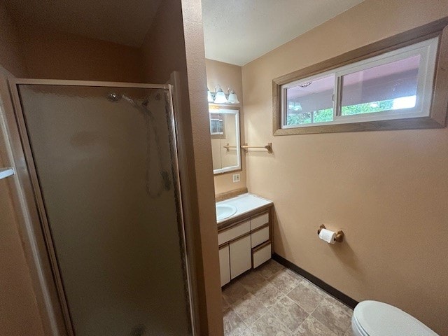 bathroom with walk in shower, vanity, and toilet