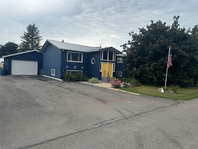 view of front facade featuring a garage and central air condition unit