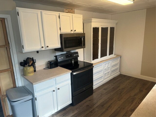 kitchen with black range with electric stovetop, white cabinets, and dark wood-type flooring