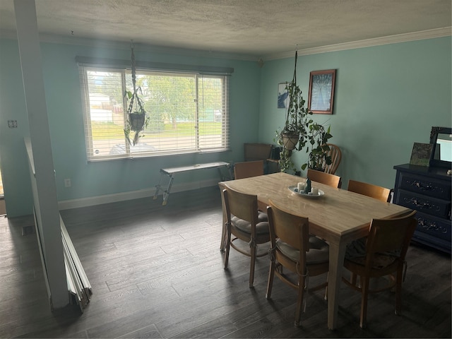 dining space featuring a textured ceiling, ornamental molding, and dark wood-type flooring