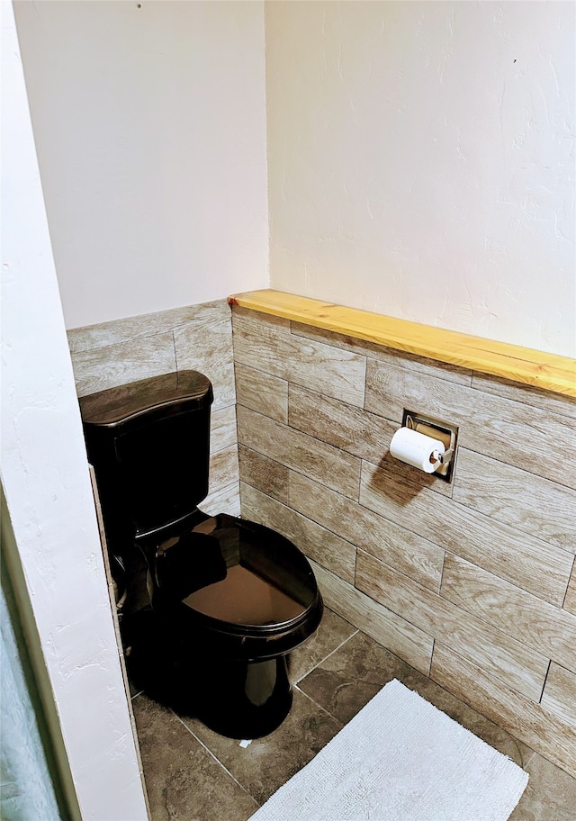 bathroom with tile patterned flooring and toilet