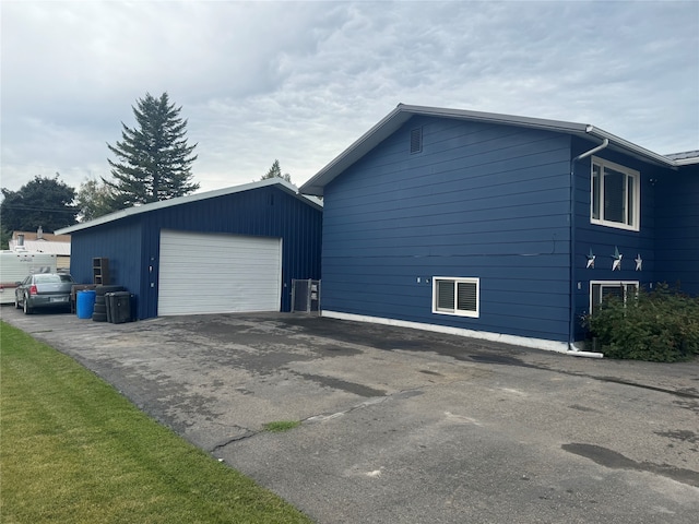 view of home's exterior featuring a garage and an outbuilding