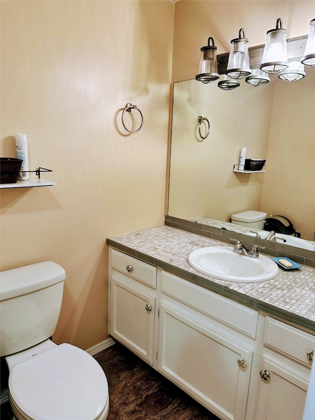 bathroom featuring vanity and toilet