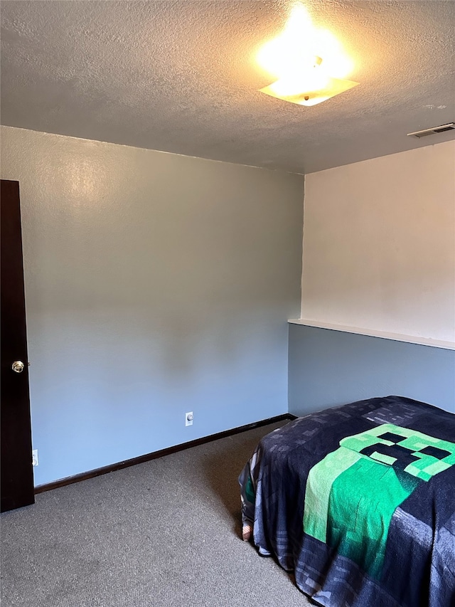 unfurnished bedroom with carpet and a textured ceiling