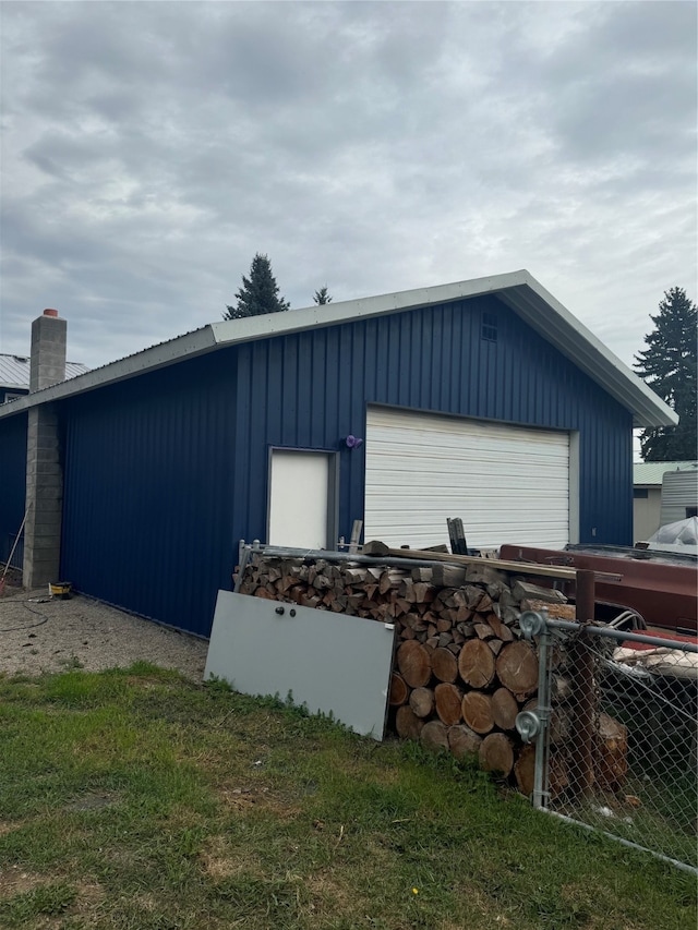 view of property exterior with an outdoor structure and a garage