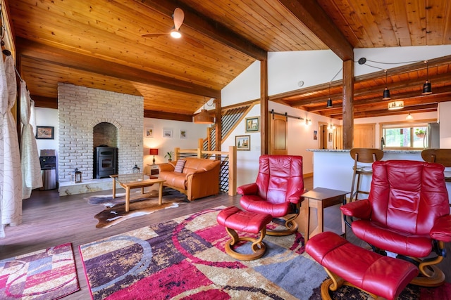 346 Crystal Lakes Dr, Eureka, MT 59917 - living room with wood finished floors, wood ceiling, a ceiling fan, a wood stove, and stairway