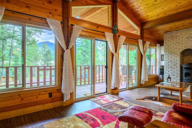 346 Crystal Lakes Dr, Eureka, MT 59917 - living area with a wood stove, wood finished floors, healthy amount of natural light, and wooden ceiling