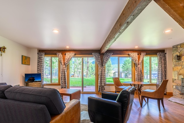 living room featuring hardwood / wood-style flooring, beamed ceiling, and a wealth of natural light