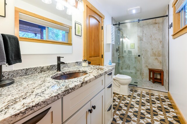 bathroom featuring walk in shower, vanity, and toilet