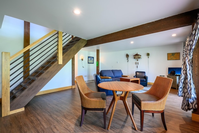 dining room featuring beam ceiling and dark wood-type flooring