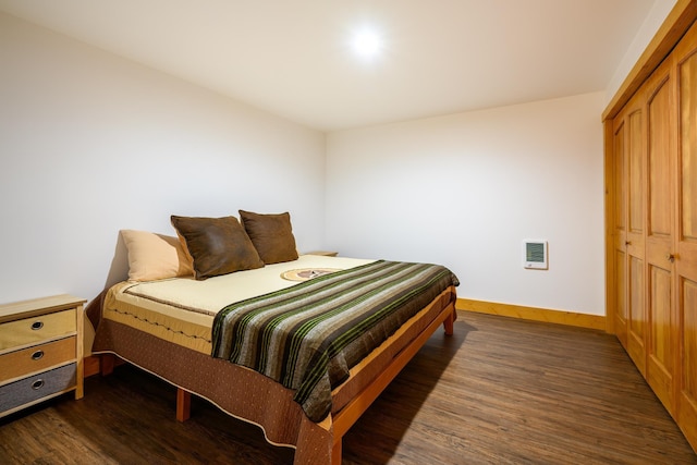 346 Crystal Lakes Dr, Eureka, MT 59917 - bedroom with dark wood finished floors, baseboards, heating unit, and a closet