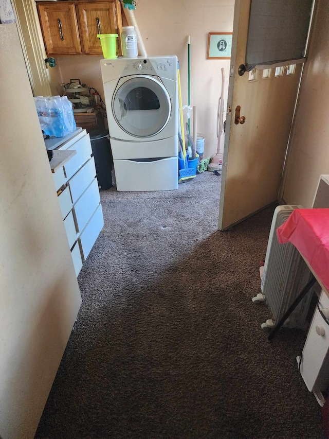 laundry room featuring washer / clothes dryer and dark colored carpet