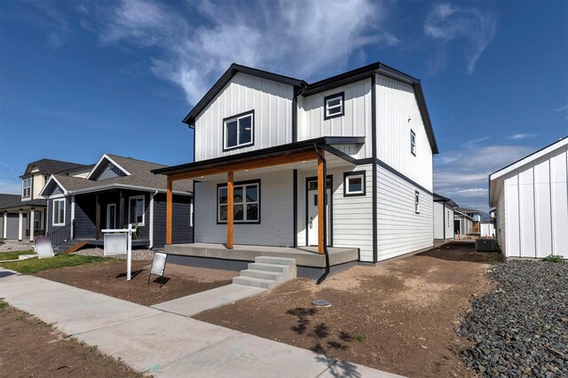 modern farmhouse with cooling unit and covered porch