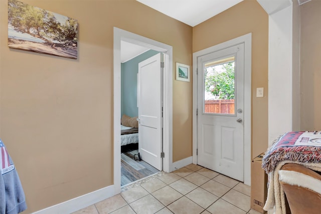 doorway with light tile patterned floors