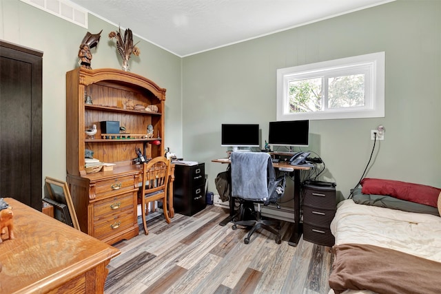 office space with light hardwood / wood-style flooring and ornamental molding