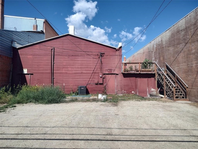 view of side of property with central AC and a deck