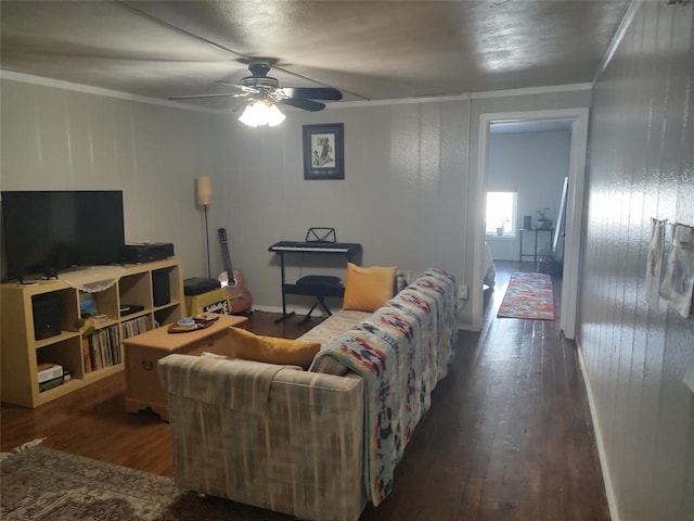 living room featuring ornamental molding, ceiling fan, and dark hardwood / wood-style flooring