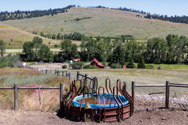 exterior space featuring a trampoline and a rural view