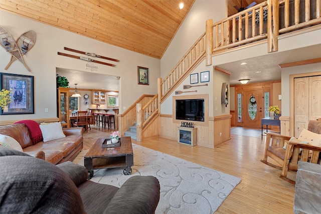 living room with high vaulted ceiling, wood ceiling, and light hardwood / wood-style floors