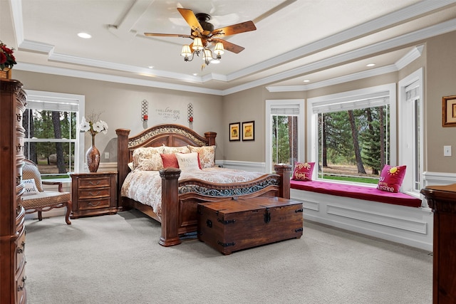 carpeted bedroom featuring crown molding, ceiling fan, and a tray ceiling