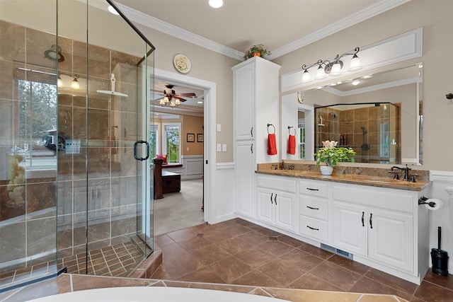 bathroom with crown molding, ceiling fan, vanity, and a shower with shower door