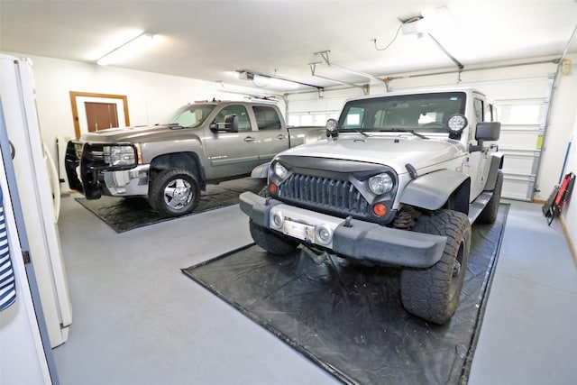 garage with white refrigerator and a garage door opener