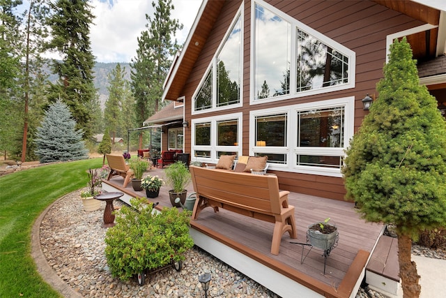 exterior space with a wooden deck, outdoor lounge area, and a yard