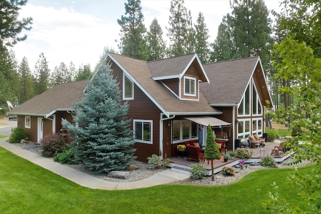 back of house with a wooden deck and a lawn