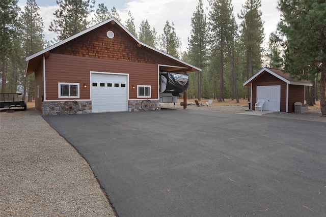 view of side of property featuring an outbuilding and a garage