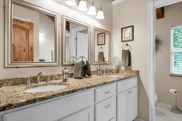 bathroom featuring crown molding, vanity, and toilet