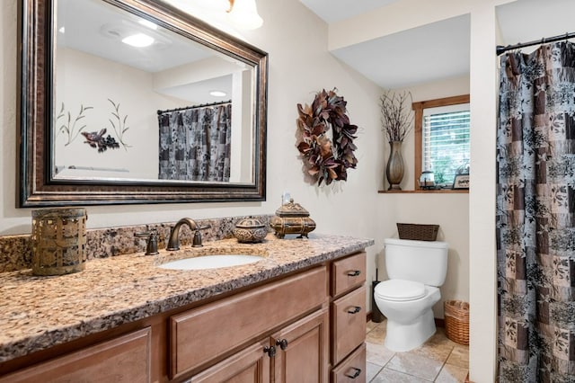 bathroom featuring tile patterned flooring, vanity, and toilet