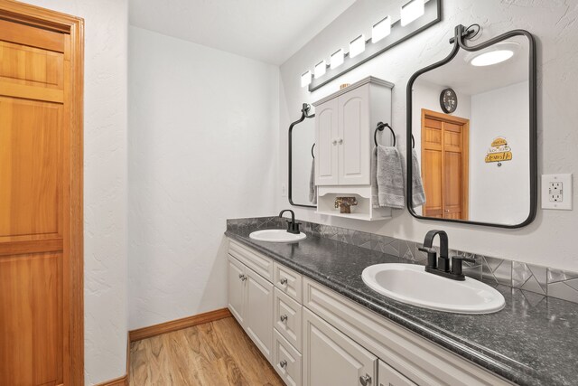 bathroom featuring hardwood / wood-style flooring and vanity