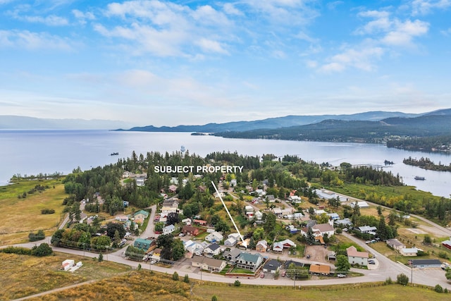 aerial view featuring a water and mountain view