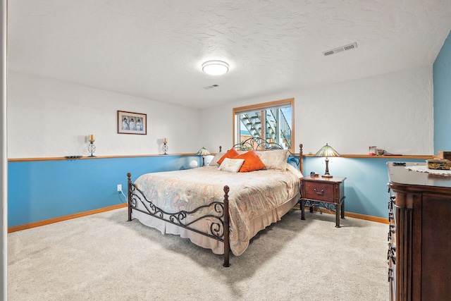 carpeted bedroom featuring a textured ceiling