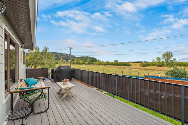 deck featuring grilling area and a rural view