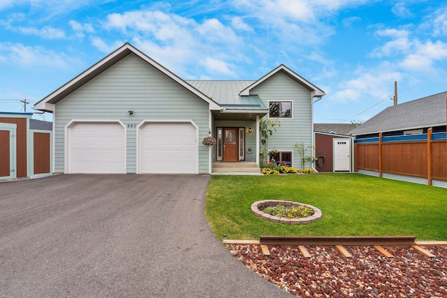 view of front of house featuring a garage and a front yard