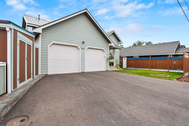 garage featuring wooden walls and a yard