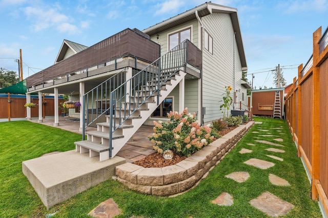 back of property with a patio, cooling unit, and a yard