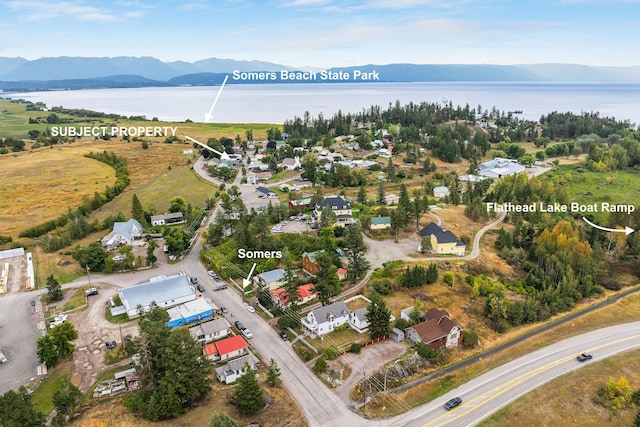 birds eye view of property featuring a water and mountain view