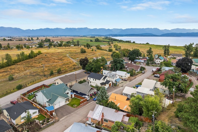 birds eye view of property with a water and mountain view