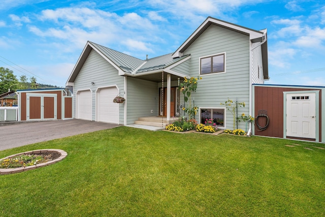 view of front of home featuring a front yard, a garage, and a shed