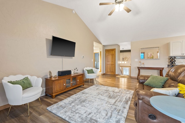 living room featuring wood-type flooring, lofted ceiling, and ceiling fan